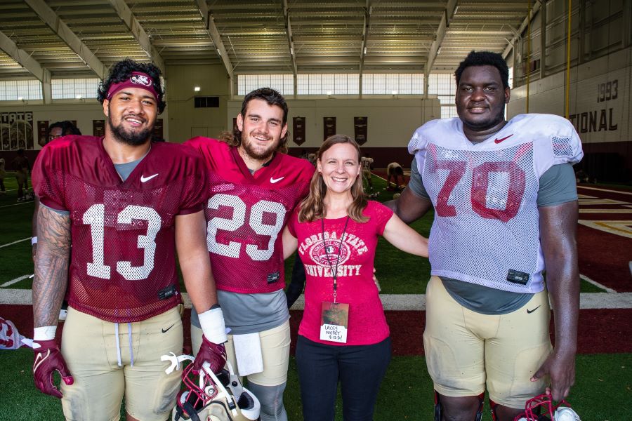 (L to R) Sione Lolohea, redshirt senior defensive end; Alex Mastromanno, redshirt senior punter; Lacey Moret, continuing F-1 immigration advisor at the CGE; and Manasse Itete, freshman lineman. (CGE/Seamus Toner)