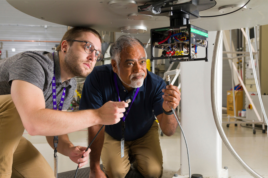 From left, postdoctoral research Sam McCalpin and Professor Ayyalusamy "Rams" Ramamoorthy hookup a probe in the bore of a magnet at the Florida State University-headquartered National High Magnetic Field Laboratory. (Scott Holstein/FAMU-FSU College of Engineering)