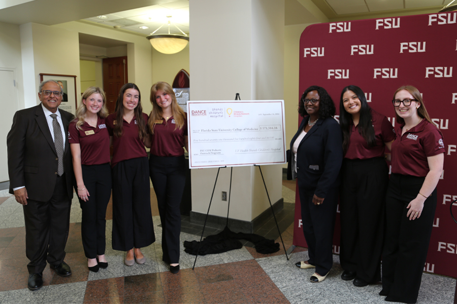 The Dance Marathon at Florida State University executive committee presents a check to Dr. Rashmin Savani, far left, chair of the University of Florida College of Medicine Department of Pediatrics and Physician-in-Chief at UF Health Shands Children's Hospital. FSU College of Medicine Dean Dr. Alma B. Littles is to the right of the check and on her immediate right is Dance Marathon at FSU Executive Director, Darcy Sullivan. (Jack Rizzo/FSU College of Medicine)