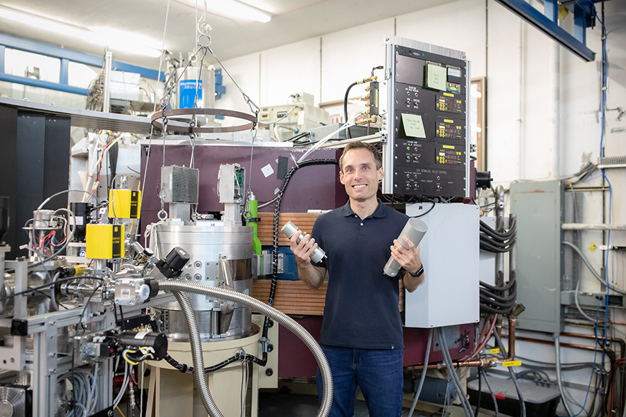 Assistant professor of physics and Fox Lab researcher Mark-Christoph Spieker holds gamma-ray detectors that are part of the Cerium Bromide Array+Super Enge Split-Pole Spectrograph system.