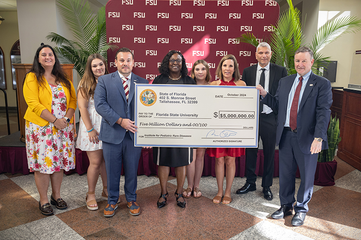 Rep. Adam Anderson, R-Palm Harbor, prsented FSU President Richard McCullough with a $5 million check from the State of Florida to support the FSU Institute for Pediatric Rare Diseases. (Bill Lax/FSU Photography Services)