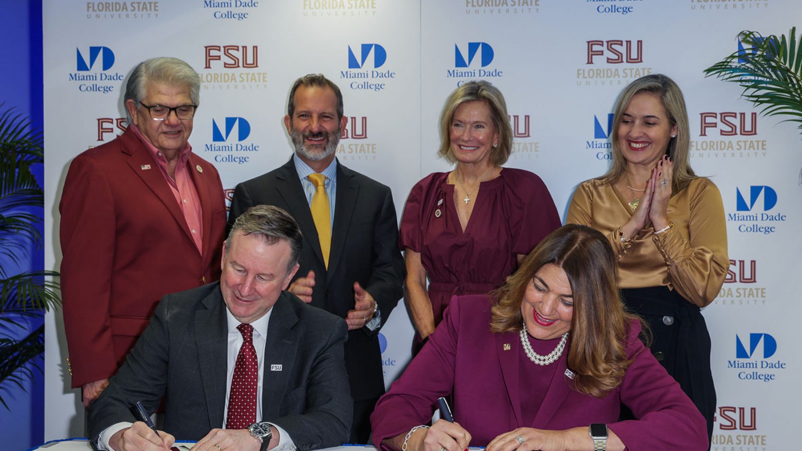 FSU President Richard McCullough and Miami Dade College President Madeline Pumariega sign an articlulation agreement to create clearer pathways and enhanced advising for MDC students to transfer to FSU. Also on hand for the signing Thursday in Miami, back row, left to right: FSU Trustee Max Alvarez, MDC Board Chairman Mike Bileca, and FSU Trustees Deborah Sargeant and Vivian de las Cuevas-Diaz. (Miami Dade College)