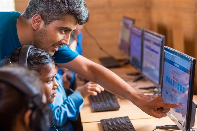 Bhushan Dahal assisting a student in Nepal. (Learning Systems Institute)