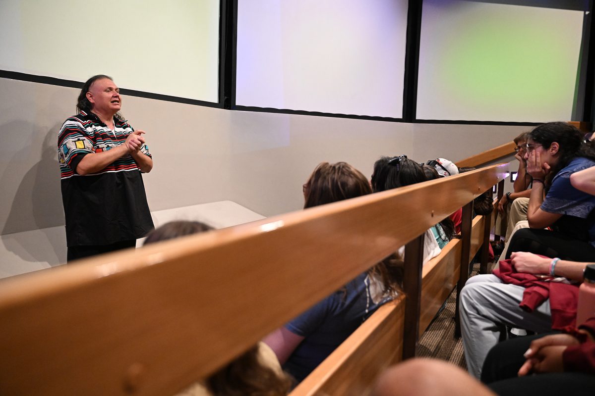 Ah-Tah-Thi-Ki Museum Director Gordon'Ollie' Wareham speaks to FSU student volunteers during the Seminole Tribe of Florida's annual American Indigenous Arts Celebration in early November 2024. (Aiden Briesacher)