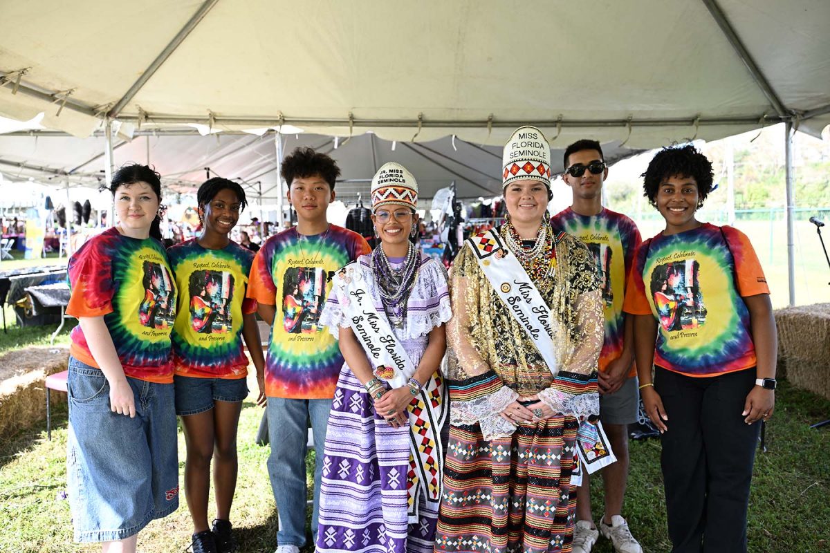 FSU student volunteers take a photo with Junior Miss Florida Seminole and Miss Florida Seminole during the Seminole Tribe of Florida's annual American Indigenous Arts Celebration in early November 2024. (Aiden Briesacher)