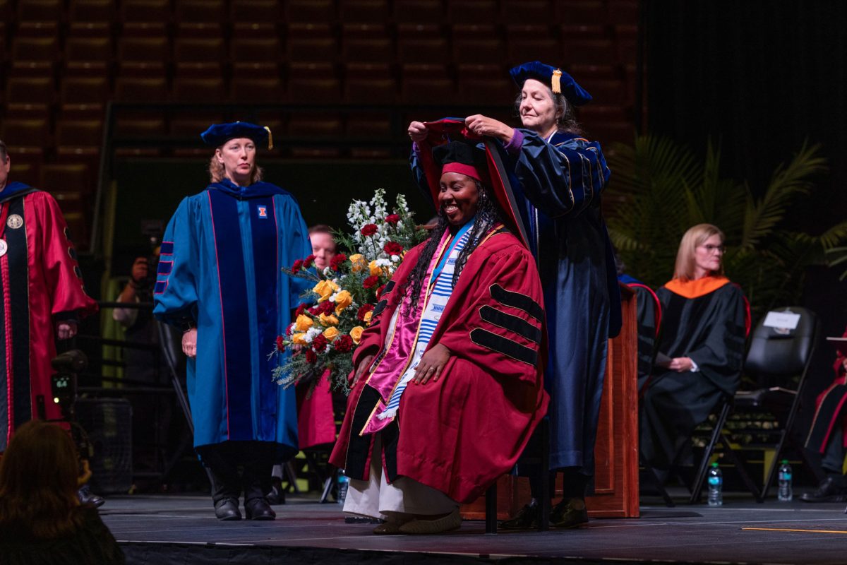 A Florida State University faculty member hoods a graduate during the fall doctoral hooding ceremony Friday, Dec. 13, 2024, at the Donald L. Tucker Civic Center. (FSU Photography)