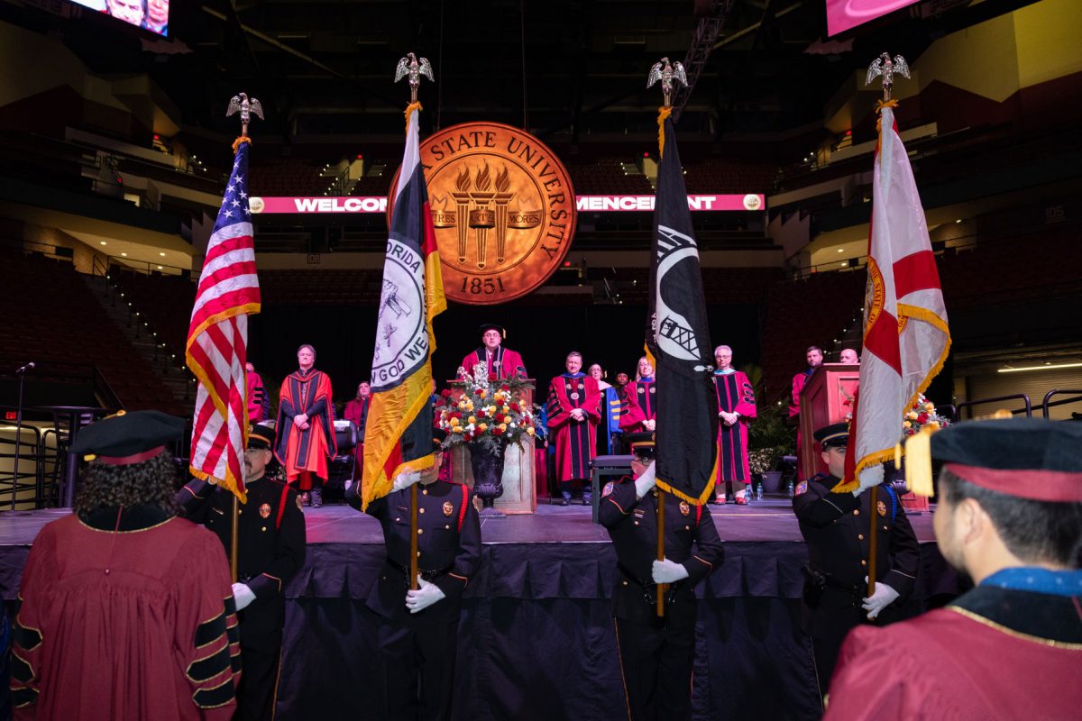 The Seminole Tribe of Florida Color Guard presents the colors at FSU's fall doctoral hooding ceremony Friday, Dec. 13, 2024, at the Donald L. Tucker Civic Center. (FSU Photography)