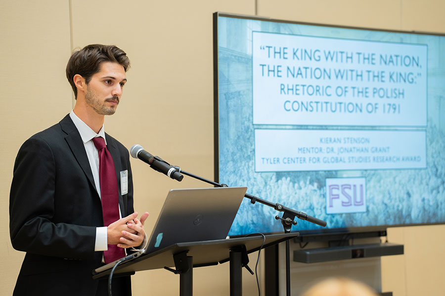 2024 Tyler Fellow Kieran Stenson, a senior graduating this fall with a degree in history, gives an oral presentation at the President's Showcase for Undergraduate Research Excellence. (Brittany Mobley, Undergraduate Studies)