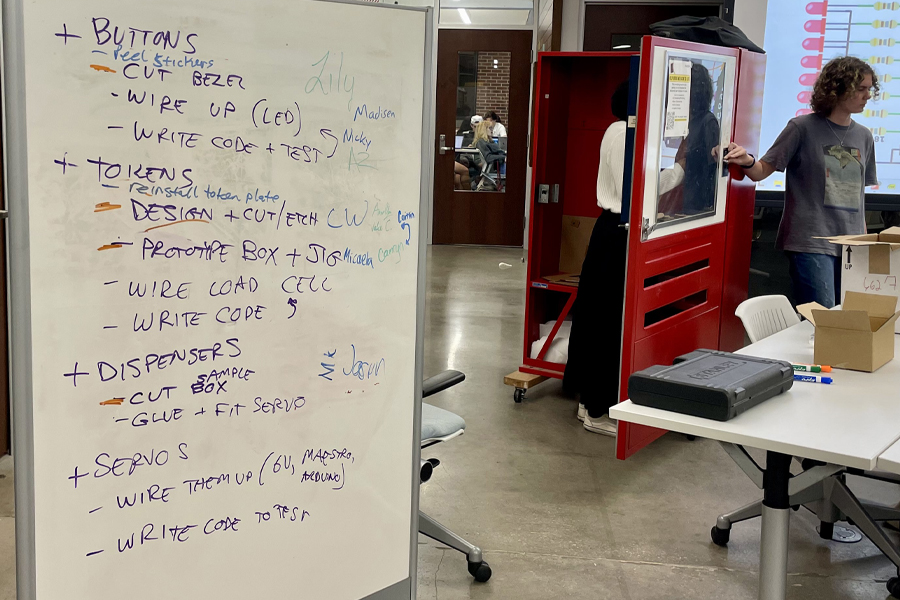 A to-do list shows tasks to be completed for the art vending machine project while students work at the Innovation Hub. (Kayla Cardenas/University Communications)