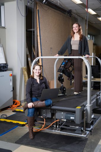 Taylor Higgins, left, assistant professor of Mechanical Engineering at the FAMU-FSU College of Engineering, is shown with undergrad student Grace Cordle who is wearing the Open Source Leg developed by the University of Michigan and sold by Humotech. The leg allows for the development of control strategies. (Scott Holstein/FAMU-FSU College of Engineering)