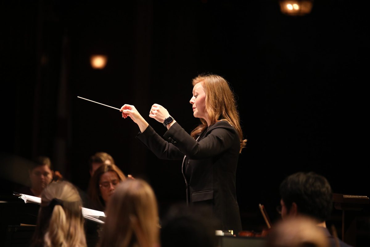 Conductor, Teacher and Vocalist, McKenna Stenson conducts during a musical number in the Sing with the Symphony event Feb. 1, 2025. (Josie Liederman)