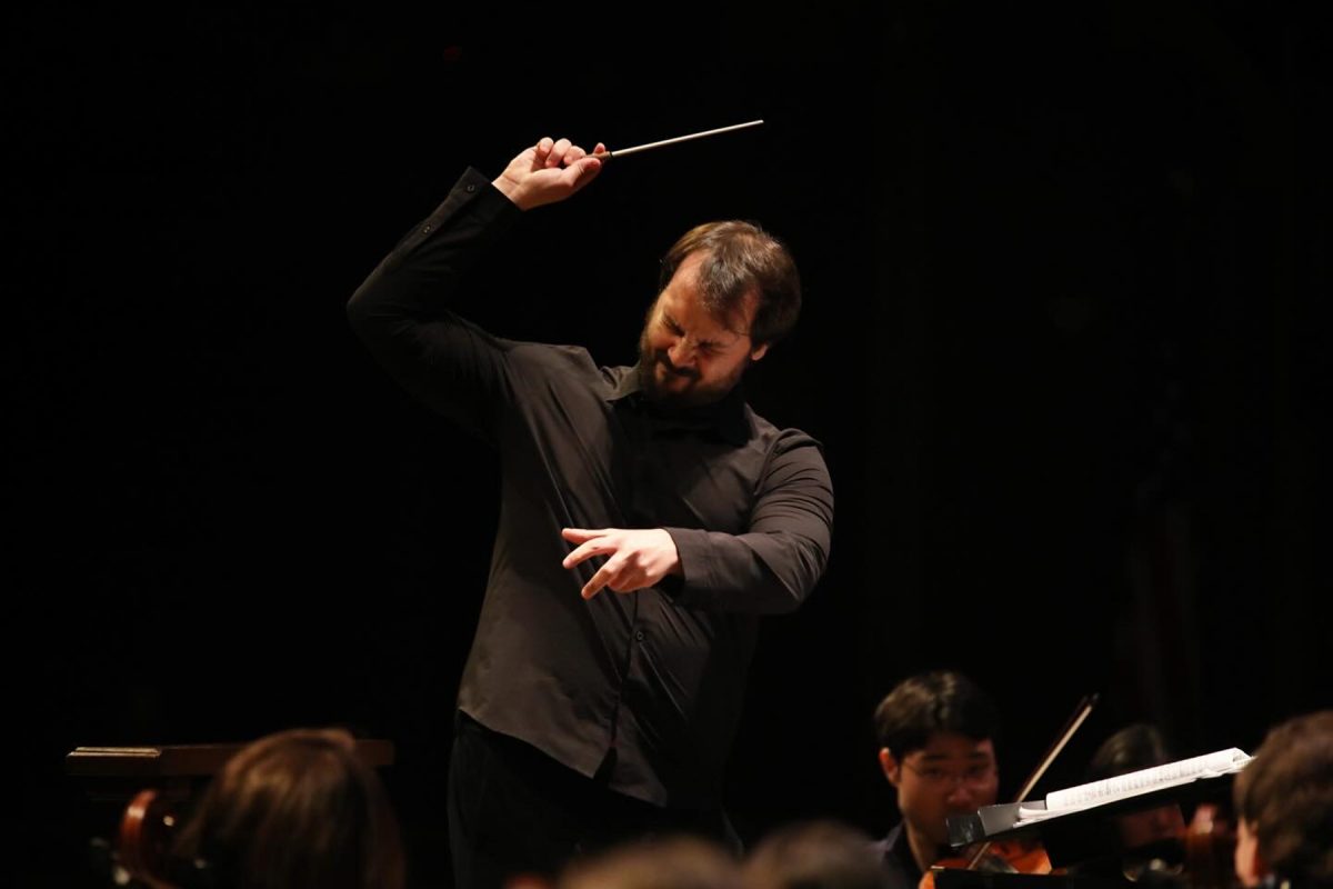 Guilherme Leal Rodrigues conducting students during a musical number in the Sing with the Symphony Feb. 1, 2025. (Josie Liederman)