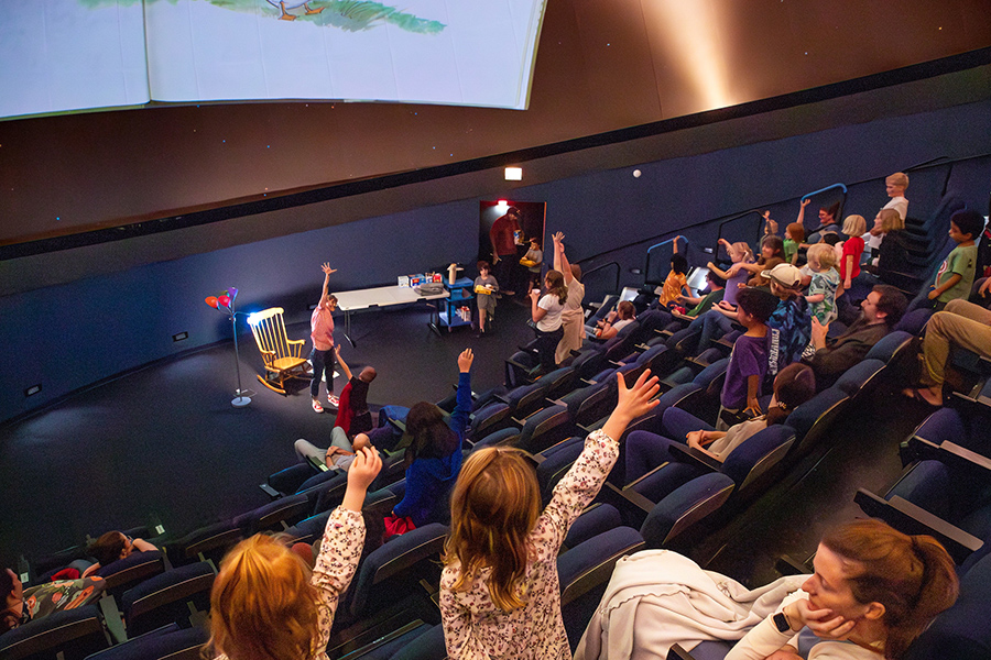 The crowd reacts during "Storytime Under the Stars," an enchanting evening for young children and families held at the Challenger Learning Center of Tallahassee as part of Florida State University's Festival of the Creative Arts. (Bob Howard/Challenger Learning Center of Tallahassee)