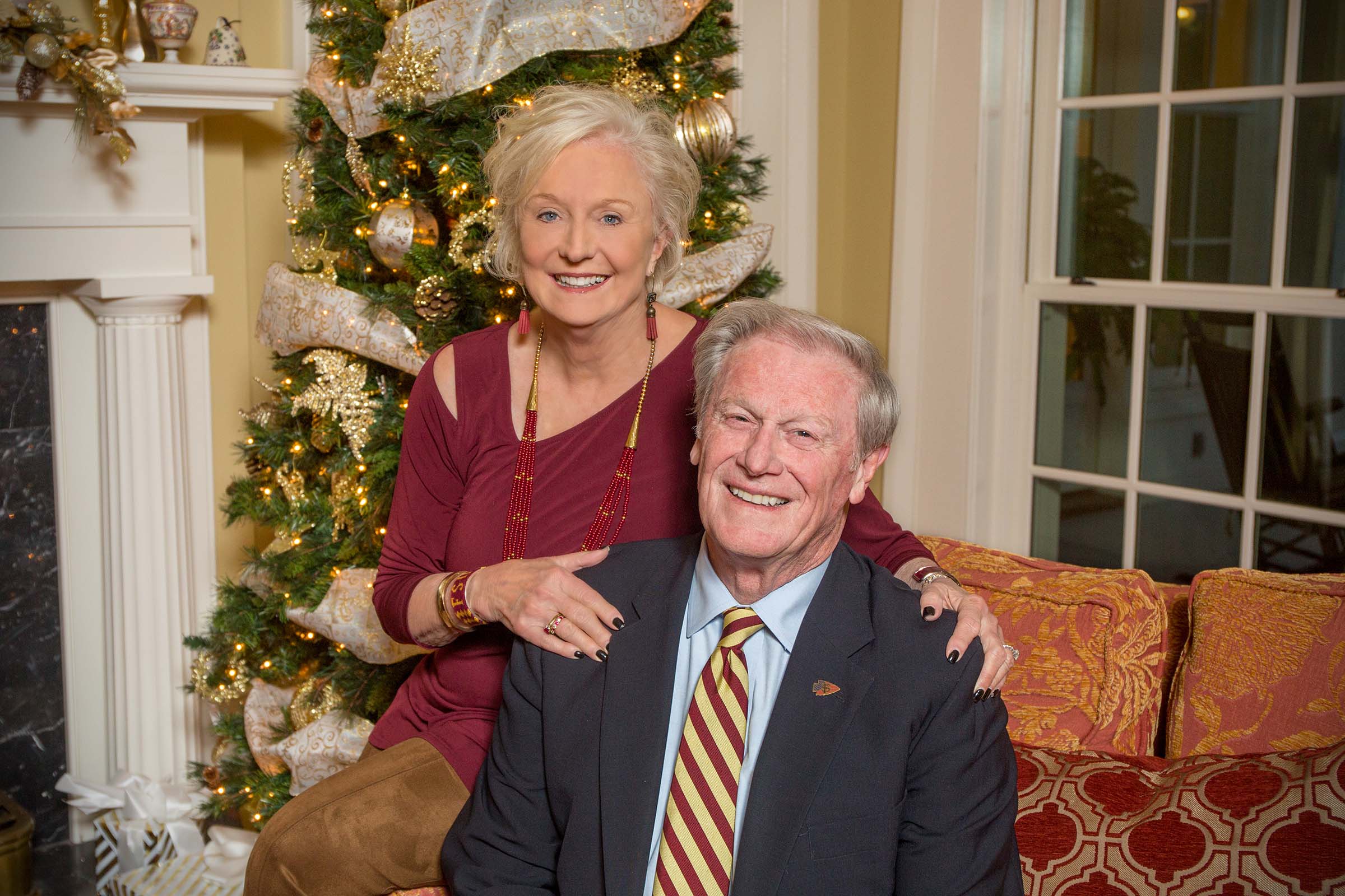 John and Jean Thrasher pose for their annual holiday photo in front of the Christmas tree at the FSU President's house in December 2017.