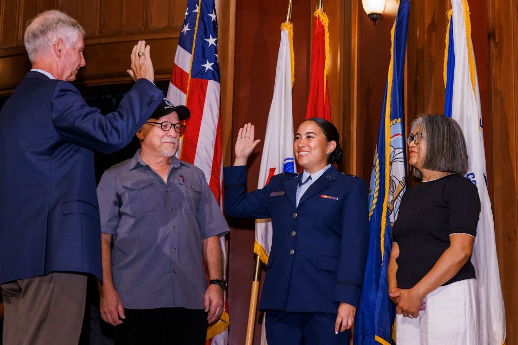 A military pinning ceremony was held prior to Saturday’s commencement, with College of Medicine Dean Emeritus, Dr. John P. Fogarty, presiding. Erika Balazs is sworn in by Dr. Fogarty as her parents, George and Nelia Balazs look on.