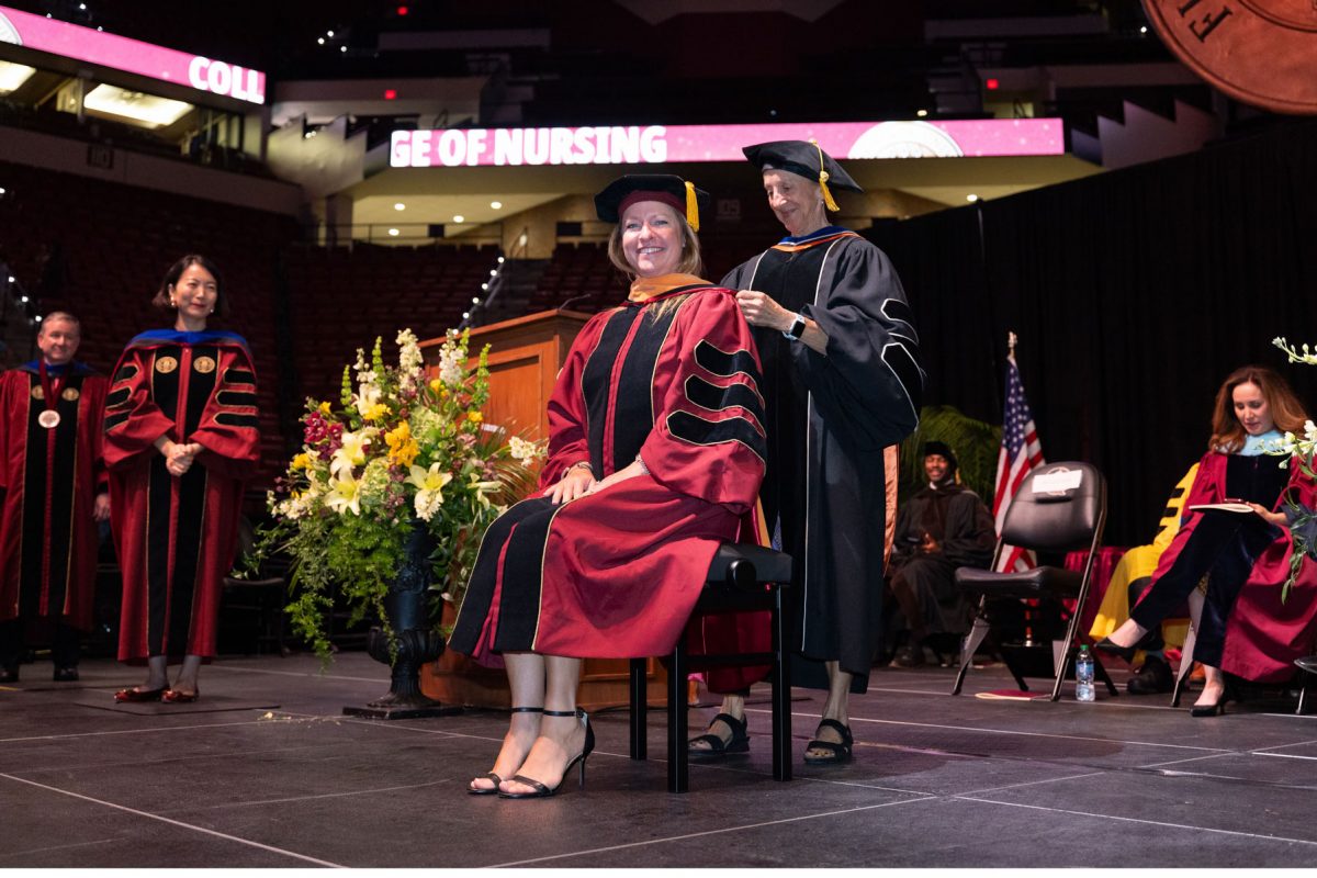 A Florida State University faculty member hoods a graduate during the spring doctoral hooding ceremony Friday, May 2, 2025, at the Donald L. Tucker Civic Center. (FSU Photography)