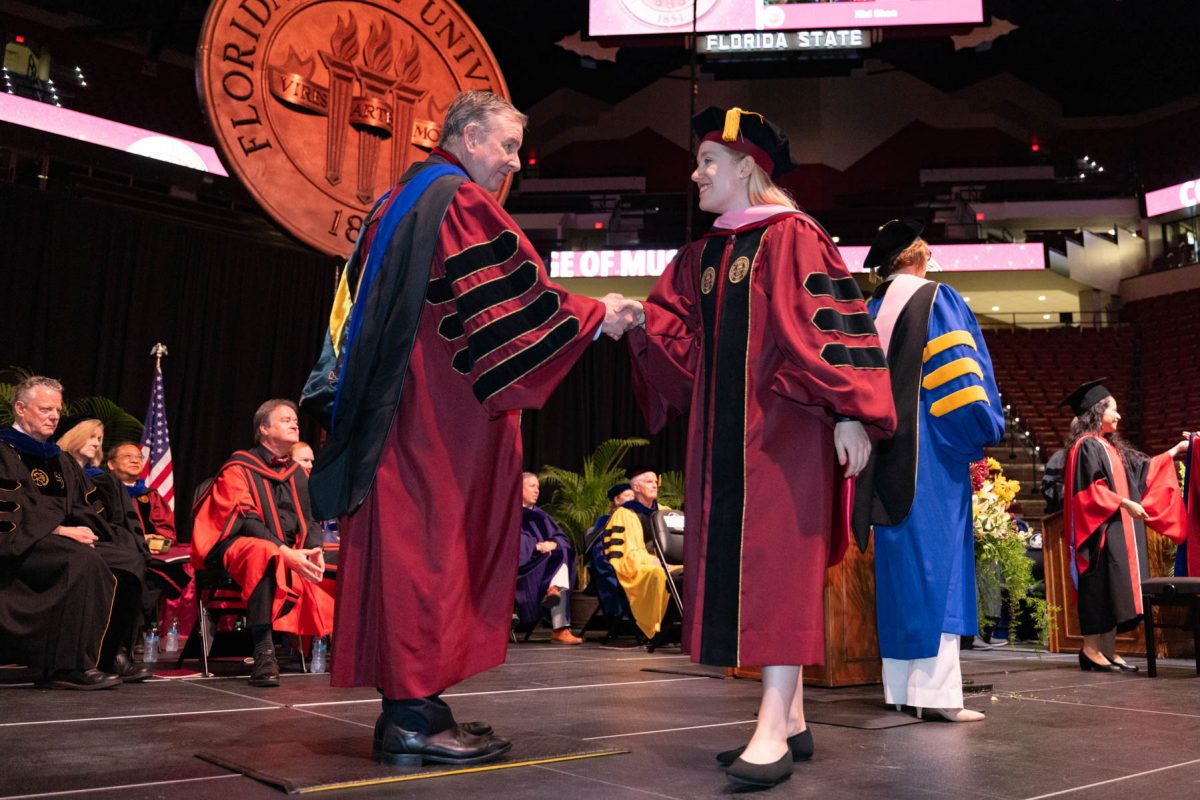 Florida State University President Richard McCullough congratulates a graduate at the university’s spring doctoral hooding ceremony Friday, May 2, 2025, at the Donald L. Tucker Civic Center. (FSU Photography)