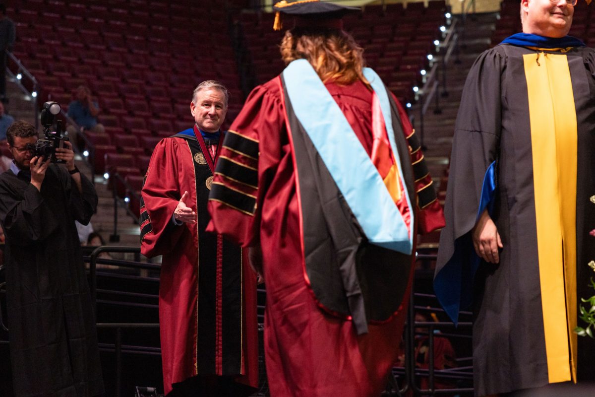 Florida State University President Richard McCullough congratulates a graduate at the university’s spring doctoral hooding ceremony Friday, May 2, 2025, at the Donald L. Tucker Civic Center. (FSU Photography)