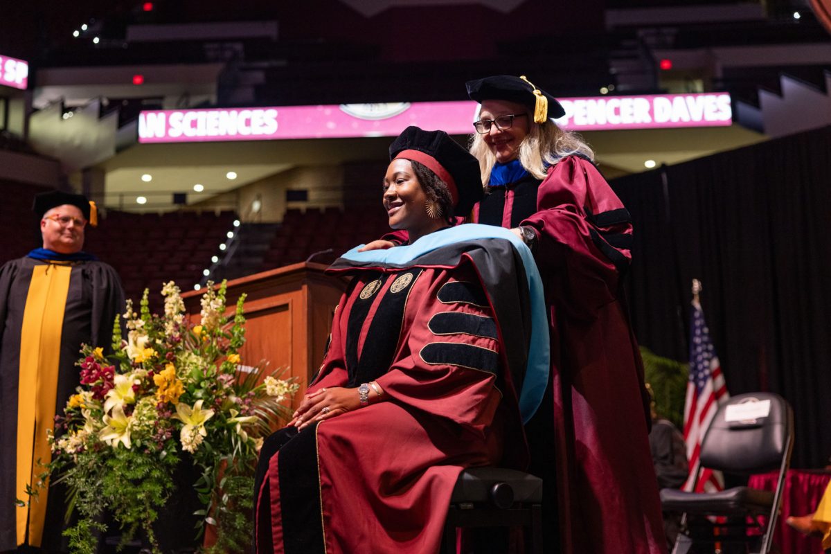 A Florida State University faculty member hoods a graduate during the spring doctoral hooding ceremony Friday, May 2, 2025, at the Donald L. Tucker Civic Center. (FSU Photography)