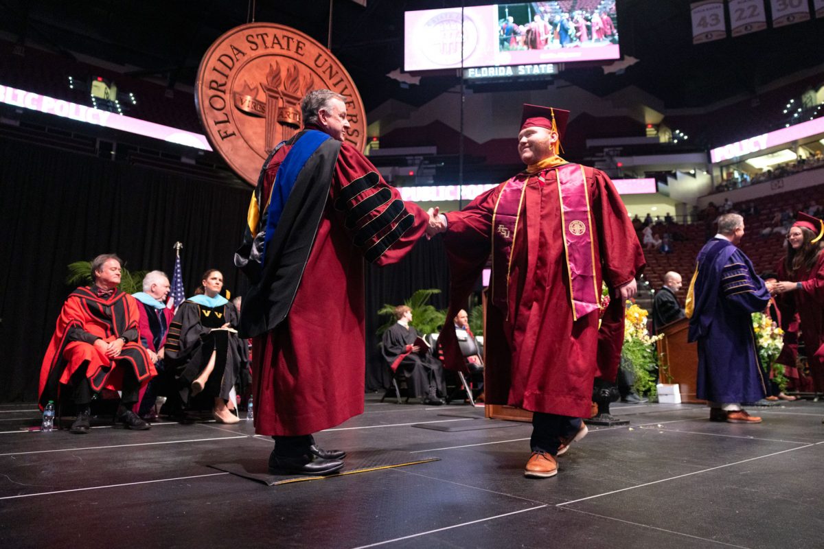 Florida State University President Richard McCullough congratulates a graduate at one of the university’s spring ceremonies Saturday, May 3, 2025, at the Donald L. Tucker Civic Center. (FSU Photography)
