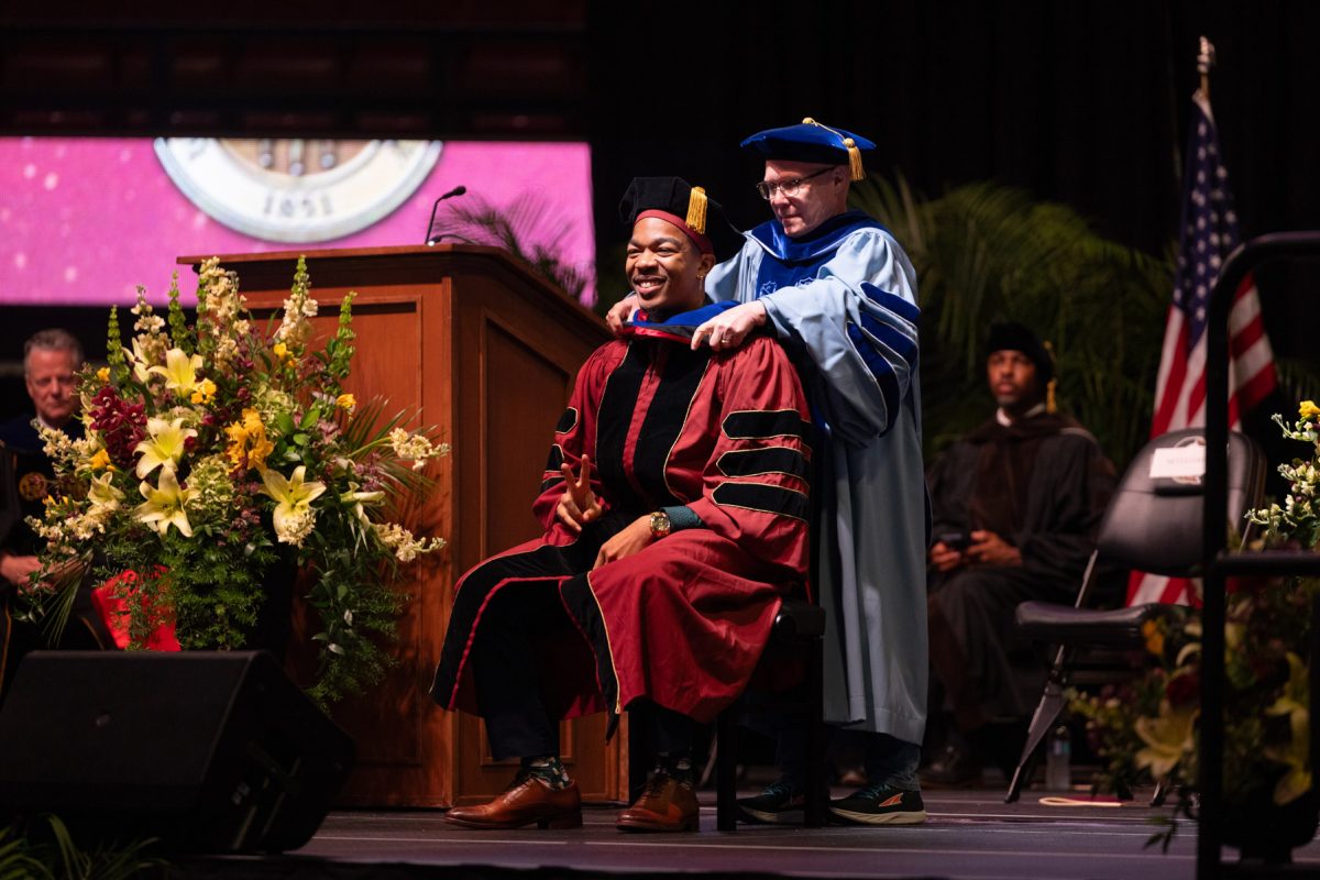 A Florida State University faculty member hoods a graduate during the spring doctoral hooding ceremony Friday, May 2, 2025, at the Donald L. Tucker Civic Center. (FSU Photography)
