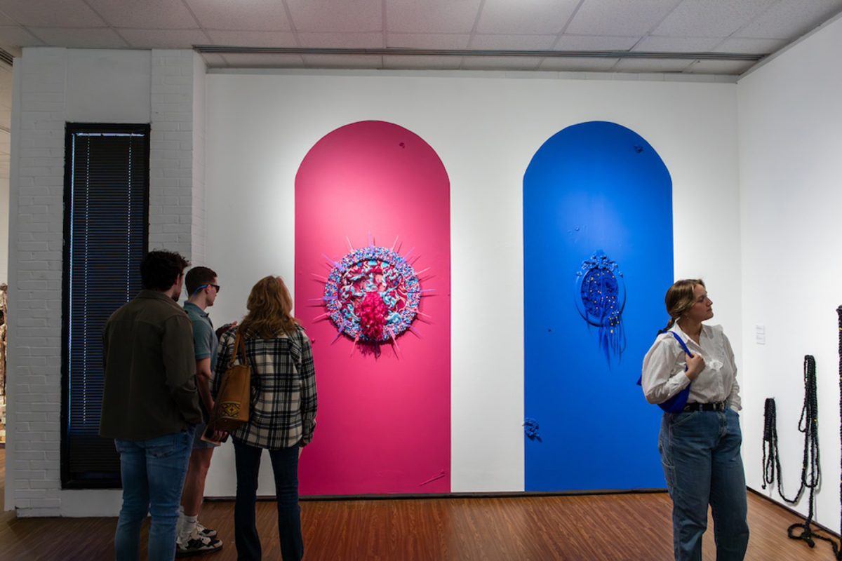 MoFA guests admire artwork by Kim Springs at the opening of “Origins & Afterlives.” (Jamie Rager/FSU College of Fine Arts)