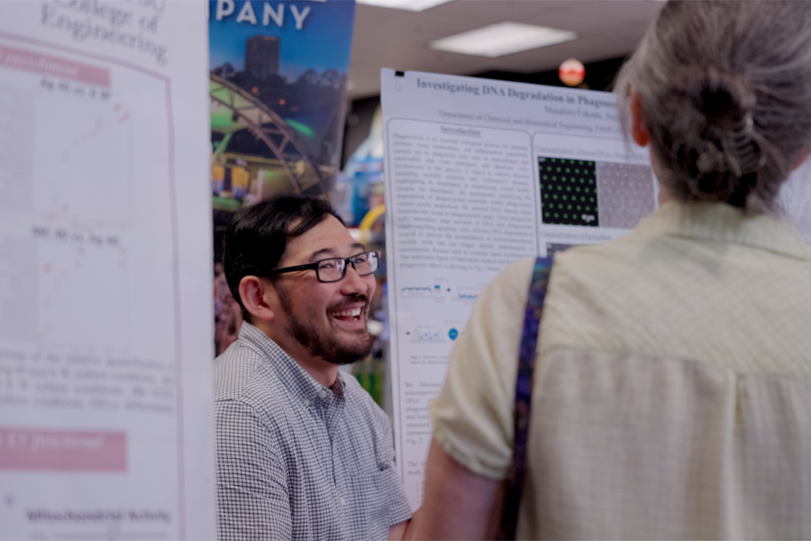 An event attendee speak about his exhibit. (Aidan Marengo/FSU iGEM)