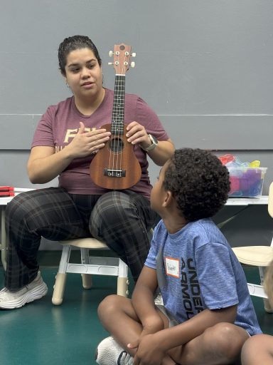 Through this five-week program, children who initially expressed feelings of isolation and bullying progressed to singing and playing instruments together in harmony. Adriana Lizardi with student and ukulele. (Photo: Dianya Markovits)