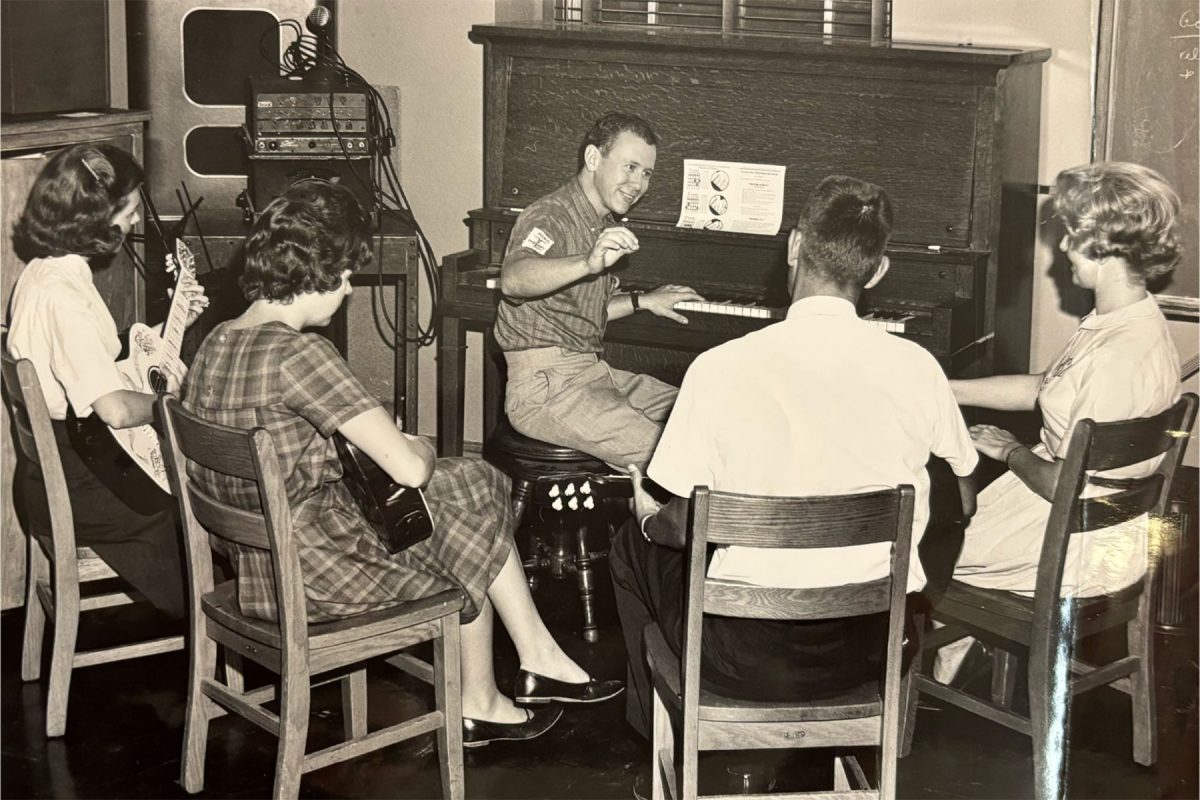 This photograph depicts a group of Music Therapy students listening to a classroom lecture by a fellow student. (FSU College of Music Archives)