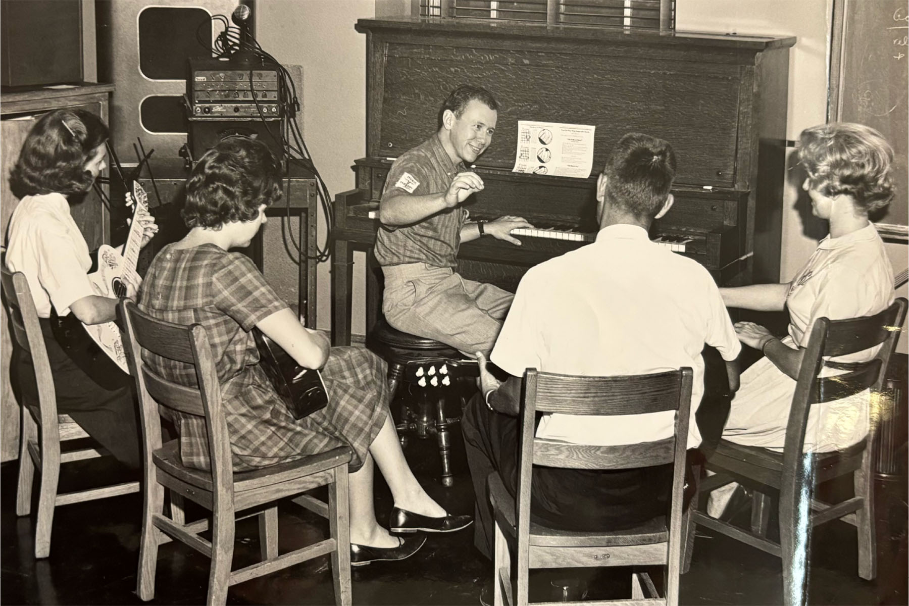 This photograph depicts a group of Music Therapy students listening to a classroom lecture by a fellow student. (FSU College of Music Archives)