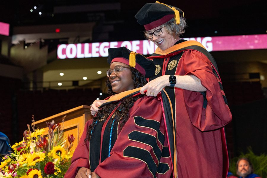 A Florida State University faculty member hoods a graduate during the summer doctoral hooding ceremony, Friday, Aug. 1, 2025, at the Donald L. Tucker Civic Center. (FSU Photography)