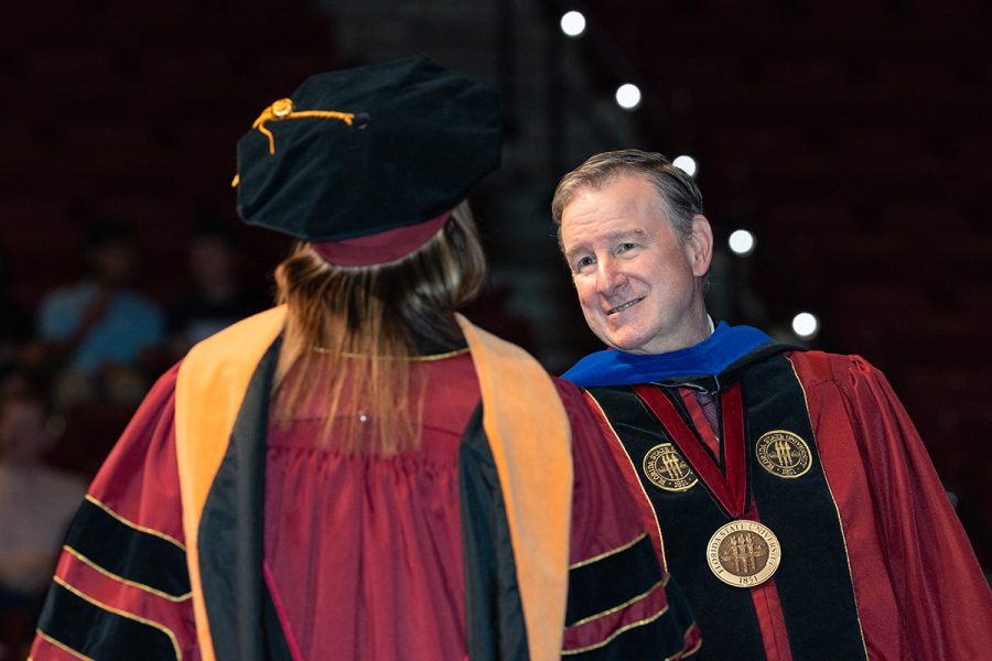 Florida State University President Richard McCullough congratulates a graduate at the university’s summer doctoral hooding ceremony, Friday, Aug. 1, 2025, at the Donald L. Tucker Civic Center. (FSU Photography)