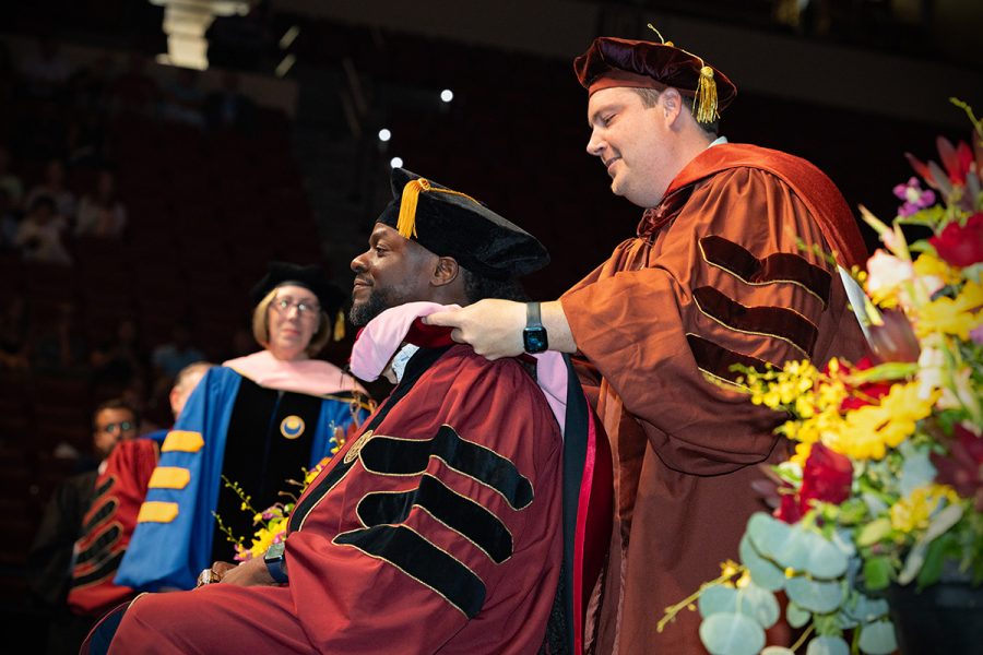 A Florida State University faculty member hoods a graduate during the summer doctoral hooding ceremony, Friday, Aug. 1, 2025, at the Donald L. Tucker Civic Center. (FSU Photography)