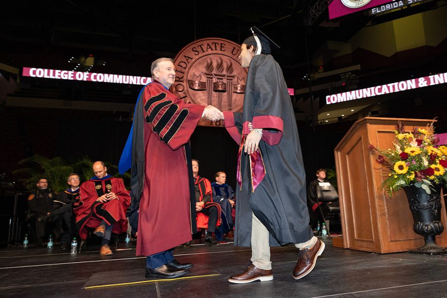 Florida State University President Richard McCullough shakes hands with a graduate during one of the summer commencement ceremonies, Friday, Aug. 1, 2025, at the Donald L. Tucker Civic Center. (FSU Photography)