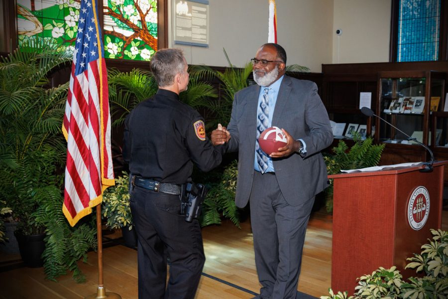 Associate Head Football Coach Odell Haggins presents Chief Trumbower with a football, a nod to his days playing for the Seminoles under Coach Bobby Bowden. (Bill Lax/FSU Photography)