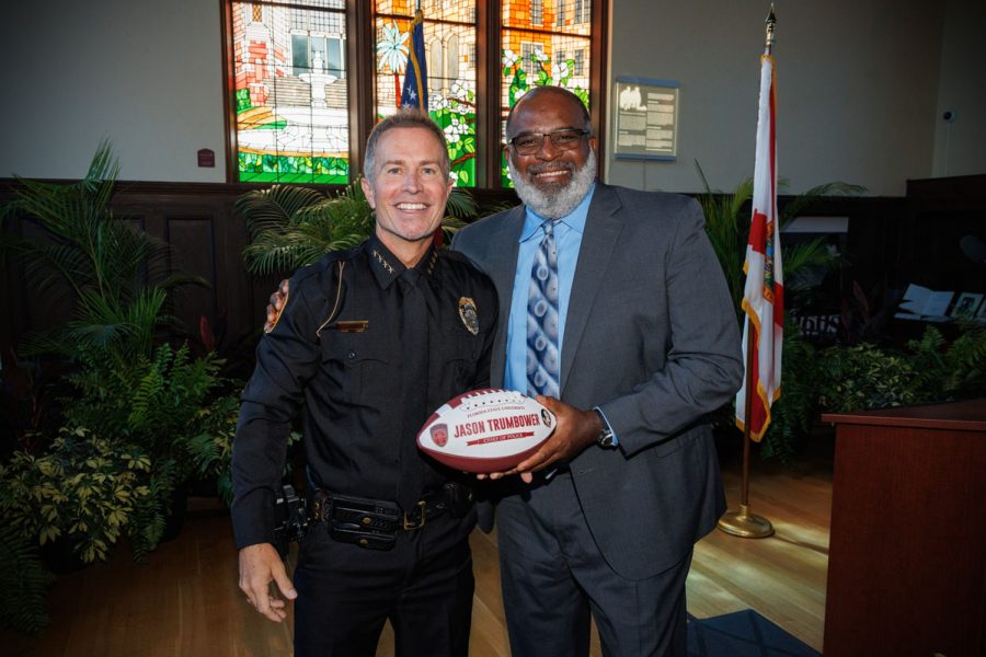 Associate Head Football Coach Odell Haggins presents Chief Trumbower with a football, a nod to his days playing for the Seminoles under Coach Bobby Bowden. (Bill Lax/FSU Photography)