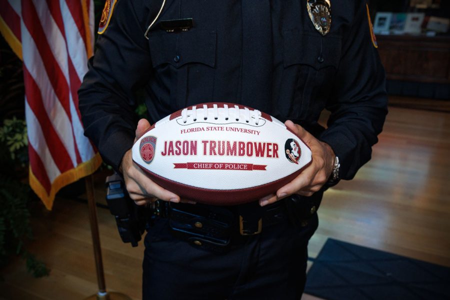 FSUPD Chief Jason Trumbower holds a souvenir football, a nod to his days playing for the Seminoles under Coach Bobby Bowden. (Bill Lax/FSU Photography)