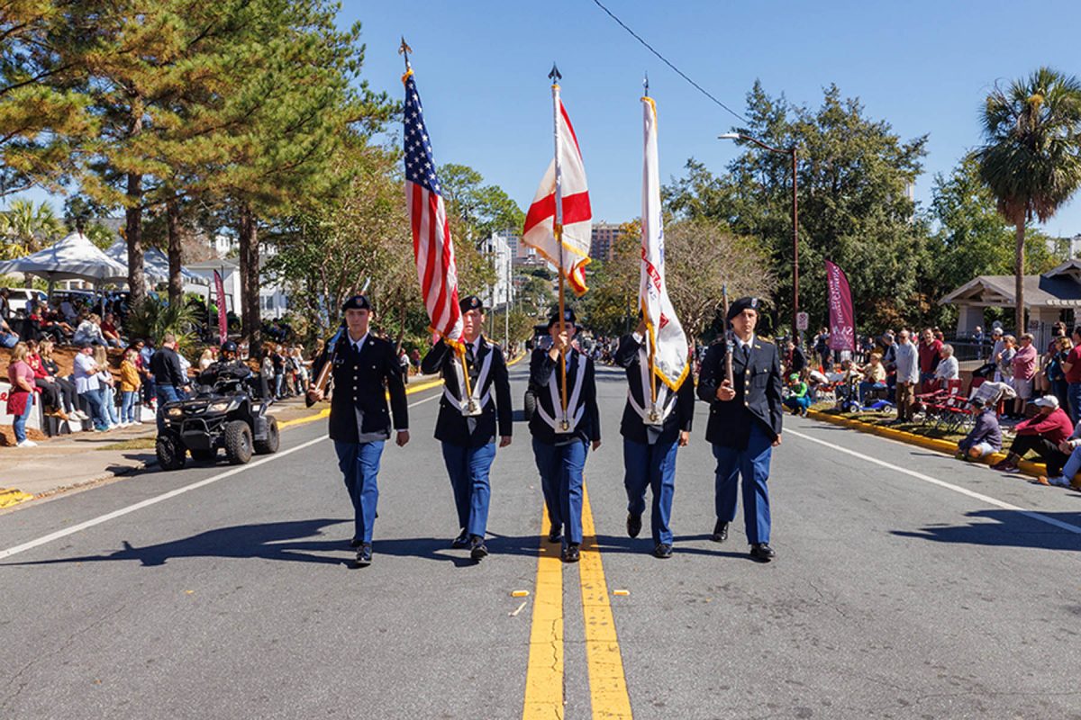 Color guard marches in 2025 FSU Homecoming Parade, Oct. 31, 2025.