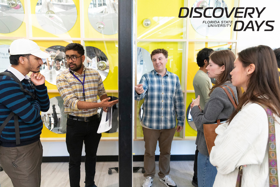 Students and postdoctoral researchers present their posters during an FSU Quantum Initiative event held during FSU Discovery Days. Explaining their work are, second from left, Shyam Raj Karullithodi, a fourth-year graduate student in the Department of Physics, and to the right, Nolan Scales, a senior undergraduate student in the Department of Physics. (Scott Holstein/FAMU-FSU College of Engineering)