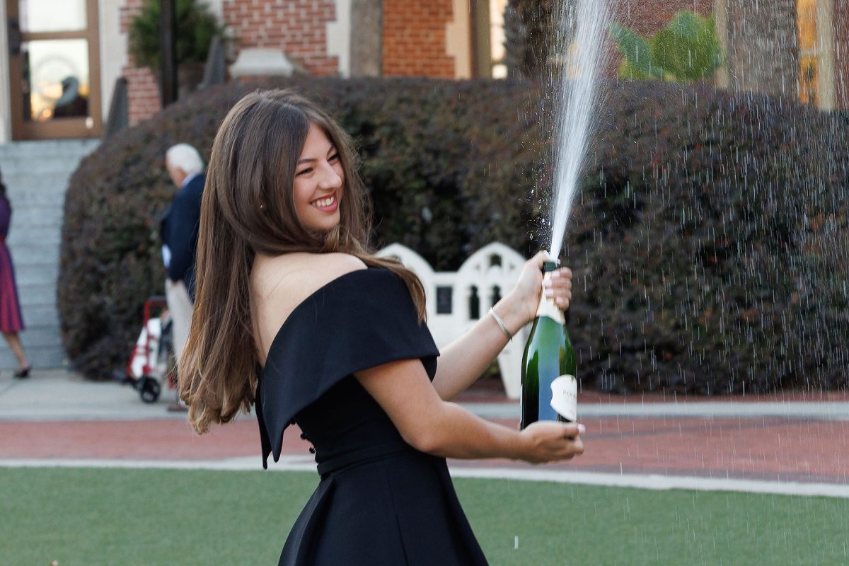 A graduate celebrates graduation at the Westcott Fountain.