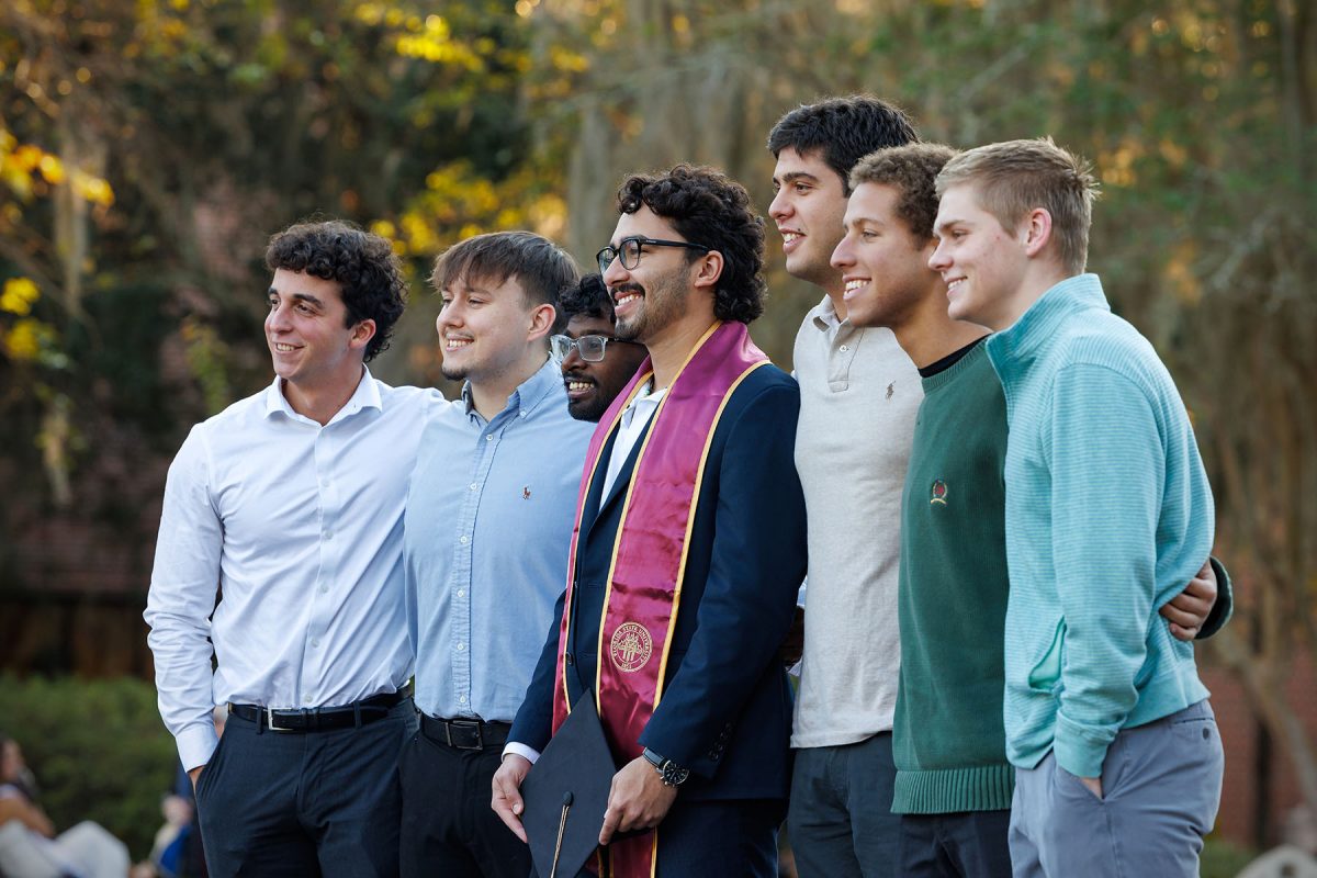 A graduate celebrates with friends at FSU’s iconic Westcott Fountain.