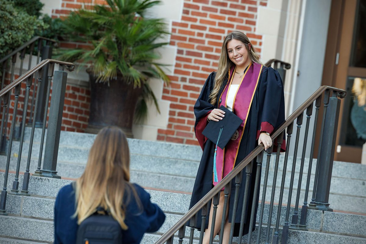 A graduate poses for photos at FSU’s historic Westcott Building. (Bill Lax/Florida State University)