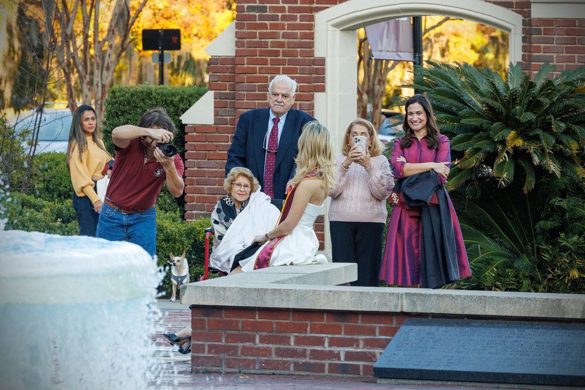 A graduate celebrates with family at FSU’s iconic Westcott Fountain. (Bill Lax/Florida State University)
