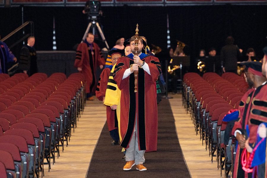 Florida State University Director of Institutional Research James Hunt carries the mace to lead the processional during summer commencement, Friday, Dec. 12, 2025, at the Donald L. Tucker Civic Center. (Bill Lax/ Florida State University)