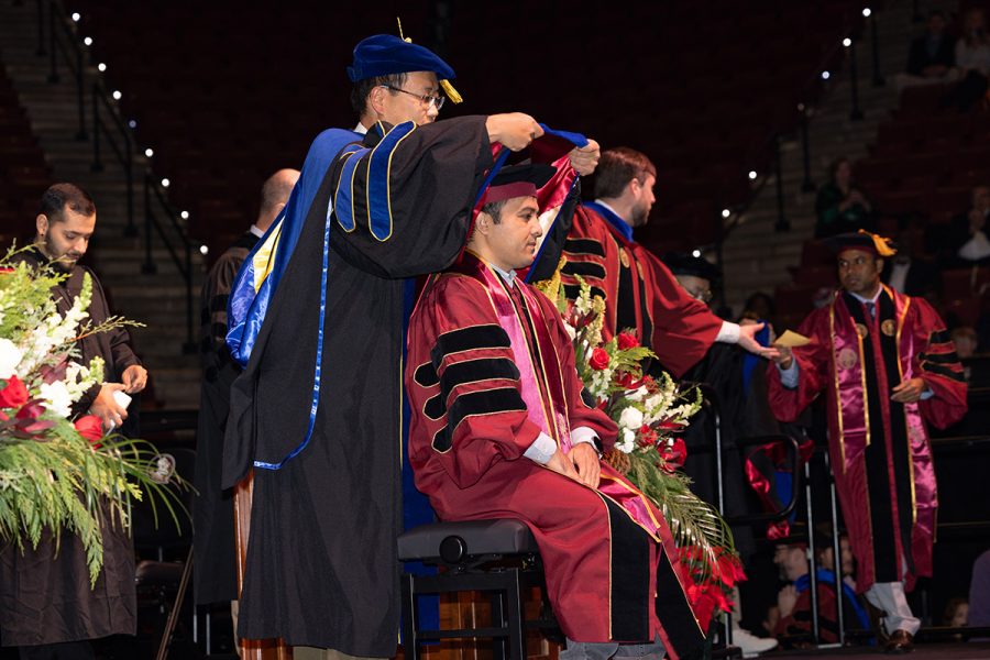 A Florida State University faculty member hoods a graduate during the summer doctoral hooding ceremony, Friday, Dec. 12, 2025, at the Donald L. Tucker Civic Center. (Bill Lax/ Florida State University)