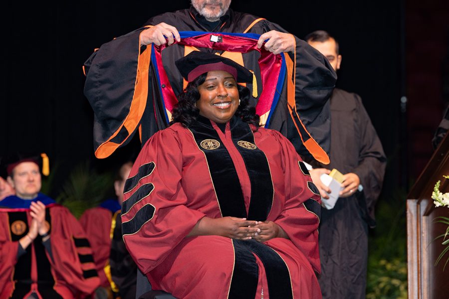 A Florida State University faculty member hoods a graduate during the summer doctoral hooding ceremony, Friday, Dec. 12, 2025, at the Donald L. Tucker Civic Center. (Bill Lax/ Florida State University)
