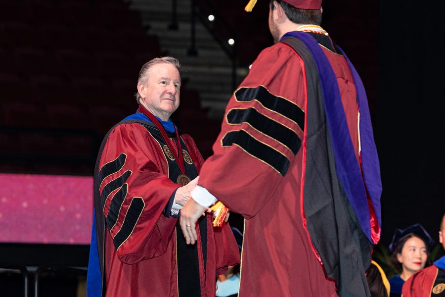 Florida State University President Richard McCullough congratulates a graduate during the fall 2025 commencement ceremony, held Friday, Dec. 12, 2025, at the Donald L. Tucker Civic Center. (Bill Lax/ Florida State University)