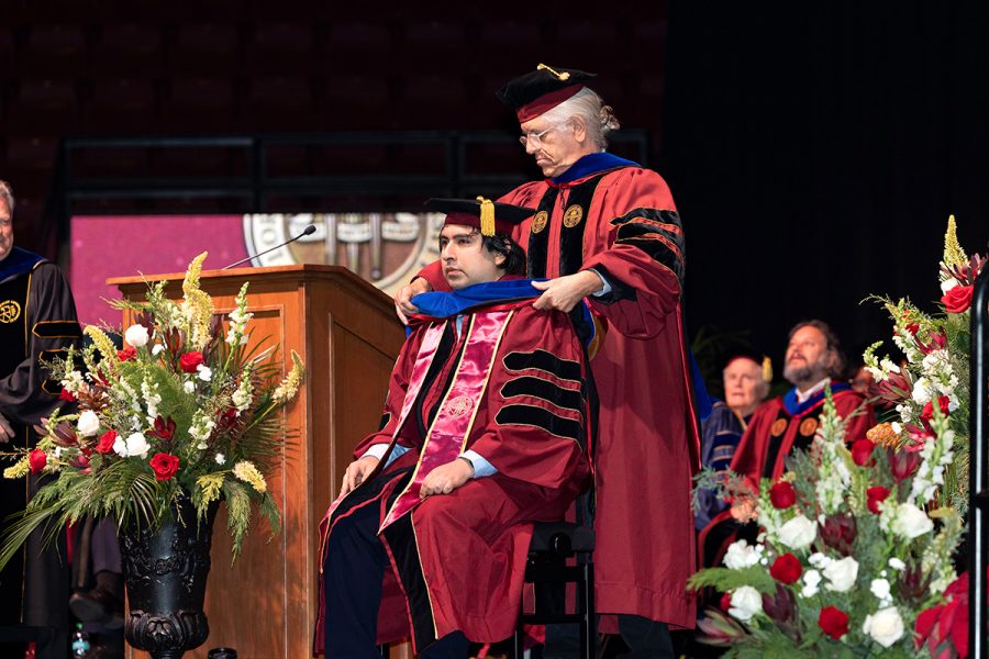 A Florida State University faculty member hoods a graduate during the summer doctoral hooding ceremony, Friday, Dec. 12, 2025, at the Donald L. Tucker Civic Center. (Bill Lax/ Florida State University)