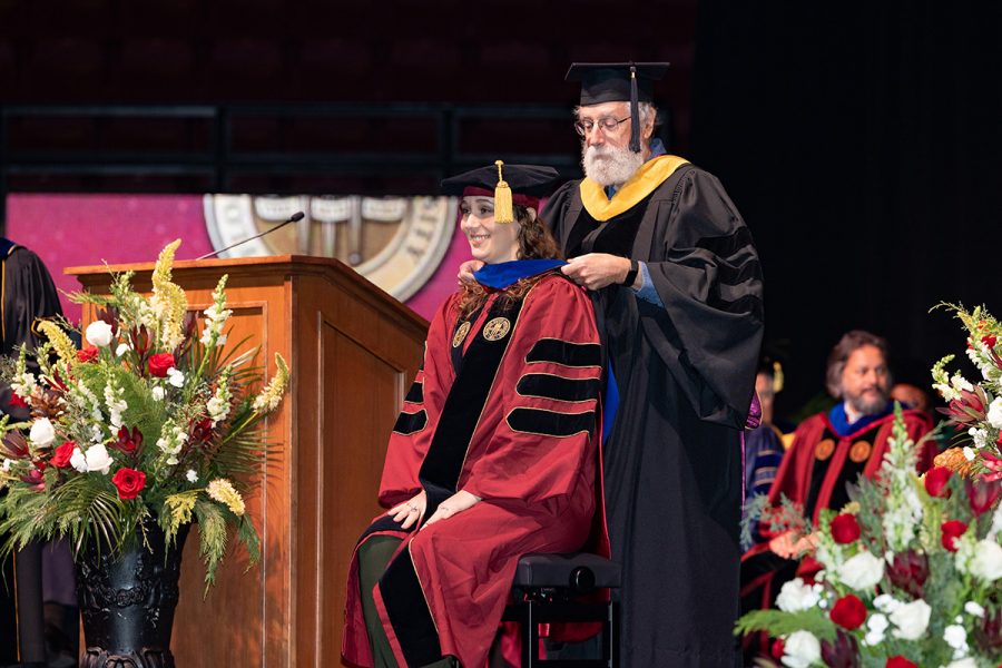 A Florida State University faculty member hoods a graduate during the summer doctoral hooding ceremony, Friday, Dec. 12, 2025, at the Donald L. Tucker Civic Center. (Bill Lax/ Florida State University)