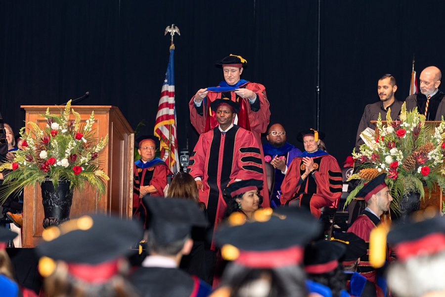 A Florida State University faculty member hoods a graduate during the summer doctoral hooding ceremony, Friday, Dec. 12, 2025, at the Donald L. Tucker Civic Center. (Bill Lax/ Florida State University)